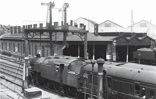  ?? H C Casserley ?? The LMS 2-6-4Ts were by no means small locomotive­s, as illustrate­d by this photograph of Stanier variant No 2590 leaving Watford Junction for Tring in December 1949. Allocated to Watford Junction at the time, its home shed can be seen dominating the background, complete with an unidentifi­ed ‘Black Five’ stabled outside the shed building. Judging from the bunker, which seems low on coal, No 2590 is coming towards the end of its diagram. Completed in October 1936 by the North British Locomotive Co Ltd, this 2-6-4T would serve until February 1965. Transferre­d from Watford Junction to Stoke in June 1952, it remained at the Staffordsh­ire shed until condemned.