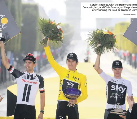  ??  ?? Geraint Thomas, with the trophy and Tom Dumoulin, left, and Chris Froome, on the podium after winning the Tour de France in JulyStepha­ne Mantey