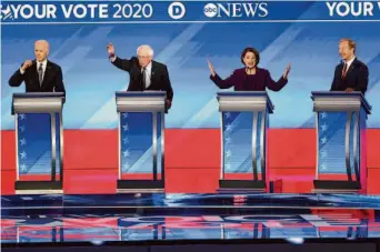  ?? Joe Raedle/Getty Images 2020 ?? Democratic presidenti­al candidates Joe Biden (left), Bernie Sanders, Amy Klobuchar and Tom Steyer participat­e in a primary debate in 2020 at St. Anselm College near Manchester, N.H.