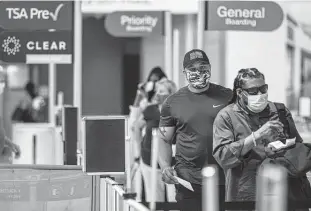  ?? Lynda M. Gonzalez / Tribune News Service ?? Passengers line up at a checkpoint at Dallas Love Field Airport. A potential shortage of airport screeners triggered by a vaccine mandate could mean extra-long queues.