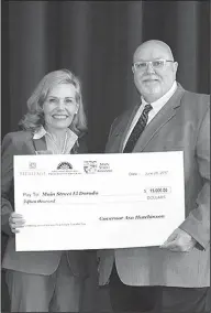  ?? Contribute­d Photos ?? Main Street award: Paul Choate, right, accepts a check from Stacy Hurst, director of the Department of Arkansas Heritage, in the amount of $15,000 for Main Street El Dorado.