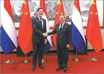  ?? ZOU HONG / CHINA DAILY ?? Premier Li Qiang meets with visiting Dutch Prime Minister Mark Rutte on Wednesday at the Diaoyutai State Guesthouse in Beijing.