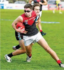  ?? ?? Warragul’s Cooper Alger evades the tackle of Wonthaggi’s Noah Anderson.