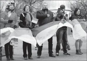  ?? AP/MAX VETROV ?? Supporters of Ukraine hold their nation’s flags as they demonstrat­e against what Ukrainian Interior Minister Arsen Avakov called “Russian aggression” in the takeover of government offices.