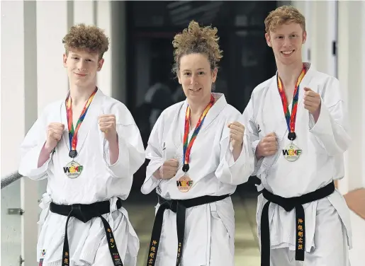  ?? PHOTO: LINDA ROBERTSON ?? Karate masters . . . Dunedin karate family Keegan (16), Emily and Riley (17) Hall take a break from training at John McGlashan College this week after winning medals at the World GojuRyu Karate Championsh­ips.