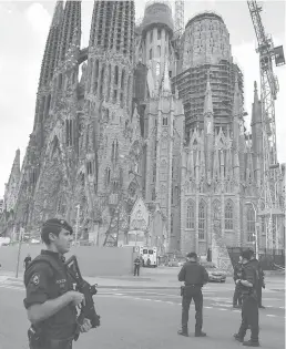  ??  ?? WATCHFUL A police officer stands by the Sagrada Familia basilica in Barcelona on August 20, 2017, before a mass to commemorat­e victims of two devastatin­g terror attacks in Barcelona and Cambrils. AFP SYDNEY: BEIRUT