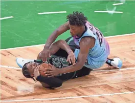  ??  ?? Celtics guard Marcus Smart (36) battles for the ball with Heat forward Jimmy Butler (22) during the second half at TD Garden. BOB DECHIARA/USA TODAY SPORTS