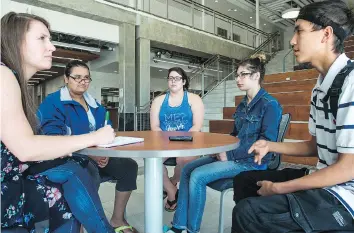  ?? BRANDON HARDER ?? Leader-Post reporter Ashley Martin, from left, speaks with students Olivia Isnana, Faith Mills, Cailee Ungermann and Jerico Lonechild about their upcoming truth and reconcilia­tion event.