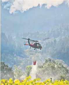  ?? — AFP photo ?? Tanker helicopter­s fight a wildfire in Oakville, California.