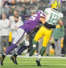  ?? ADAM BETTCHER/GETTY IMAGES ?? Minnesota Vikings linebacker Anthony Barr tackles Green Bay Packers quarterbac­k Aaron Rodgers early in Sunday’s game in Minneapoli­s. Barr later left the game with a concussion.