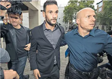  ??  ?? Hugo Lloris, centre, the Spurs and France goalkeeper, arrives at Westminste­r magistrate­s’ court to face charges of drink-driving