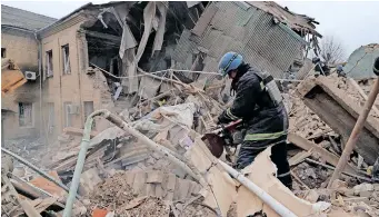  ?? | AFP ?? A RESCUE team member clears the debris of a destroyed two-storey maternity building in the town of Vilnyansk, southern Zaporizhzh­ia region, yesterday, amid the Russian invasion of Ukraine.