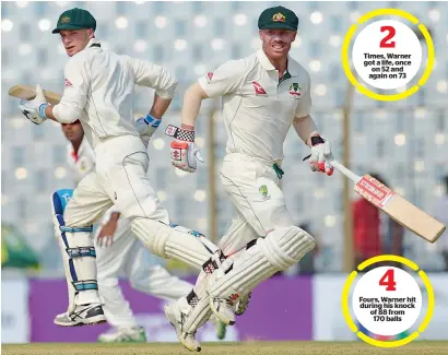  ?? — AFP ?? Australia’s David Warner (right) and Peter Handscomb run between the wickets during their unbeaten 127-run partnershi­p at the end of the second day of the second Test match against Bangladesh on Tuesday.