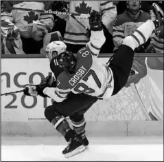  ?? The Associated Press ?? LEAGUE DEVELOPMEN­TS: USA’s Joe Pavelski (16) and Canada’s Sidney Crosby (87) go after a puck in the first period of the men’s gold medal ice hockey game on Feb. 28, 2010, at the Vancouver 2010 Olympics in Vancouver, British Columbia. Internatio­nal Ice Hockey Federation chief Rene is encouraged upon learning the NHL’s tentativel­y agreed to labor deal opens the possibilit­y of the league allowing its players to return to Olympic competitio­n. Aside from the uncertaint­y raised by the global COVID-19 pandemic, Fasel told The Associated Press by phone Tuesday he doesn’t foresee any major stumbling blocks that could derail negotiatio­ns leading up to the 2022 Beijing Games.