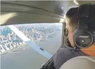  ?? The Associated Press Joshua Replogle, ?? In an image made from a video, Aaron Ludomirski, a certified flight instructor for Infinity Flight Group, flies over the Hudson River in New York.