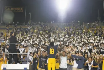  ?? Lachlan Cunningham / Getty Images ?? Wide receiver Maurice Ways, a senior who transferre­d from Michigan, conducts the Cal band after the Bears defeated then-No. 15 Washington 12-10 at Memorial Stadium on Saturday.