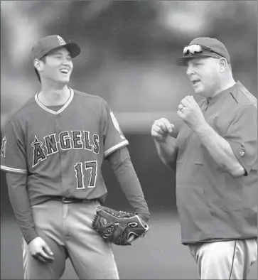  ?? Ben Margot Associated Press ?? WHO KNOWS if Shohei Ohtani can understand what Mike Scioscia is telling him? But it must be funny.