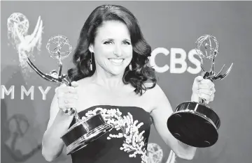  ??  ?? Louis-Dreyfus holds her Emmys for Outstandin­g Lead Actress in a Comedy Series and Outstandin­g Comedy Series for ‘Veep’ during the 69th Primetime Emmy Awards recently. —Reuters file photo