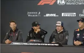  ?? DARREN ABATE — THE ASSOCIATED PRESS ?? Haas driver Romain Grosjean, of France, Mercedes driver Lewis Hamilton, of Britain, McLaren driver Fernando Alonso, of Spain, from left, listen as Red Bull Racing driver Daniel Ricciardo, of Australia, speaks during a news conference for the Formula One U.S. Grand Prix auto race at the Circuit of the Americas, Thursday, Oct. 18, 2018, in Austin, Texas.