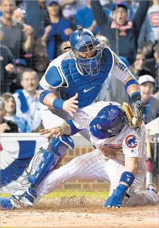  ?? Wally Skalij Los Angeles Times ?? CHICAGO’S Javier Baez beats Dodgers catcher Carlos Ruiz’s tag in the second inning to complete the Cubs’ first steal of home in a postseason game since 1907. The play gave Chicago a 3-0 lead.