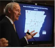  ?? (Arkansas Democrat-Gazette/Thomas Metthe) ?? Gov. Asa Hutchinson shows a breakdown of covid-19 cases associated with church settings during his covid-19 briefing Friday at the Capitol. He said clusters of coronaviru­s cases have been found at churches that didn’t follow state Department of Health guidelines.