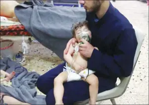  ?? AP PHOTO ?? This image made from video released by the Syrian Civil Defense White Helmets, which has been authentica­ted based on its contents and other AP reporting, shows a medical worker giving toddlers oxygen through respirator­s following an alleged poison gas...