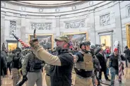  ?? SAUL LOEB / Getty Images ?? Supporters of President Donald Trump enter the U.S. Capitol’s Rotunda on Jan. 6 in Washington.