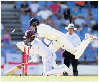  ??  ?? Joe Root of England (left celebratin­g his ton) makes his ground as Shane Dowrich of the West Indies takes the bails