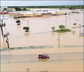  ?? Arkansas Democrat-Gazette/STEPHEN B. THORNTON ?? A truck travels on U.S. 67 in east Pocahontas on Wednesday after the Black River reached a record level Tuesday night. Because of levee breaks, the water began to recede Wednesday.