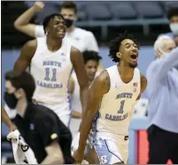  ?? ROBERT WILLETT — THE NEWS & OBSERVER VIA AP ?? North Carolina’s Leaky Black (1) and teammates celebrate at the end of the team’s win over Duke on Saturday in Chapel Hill, N.C.