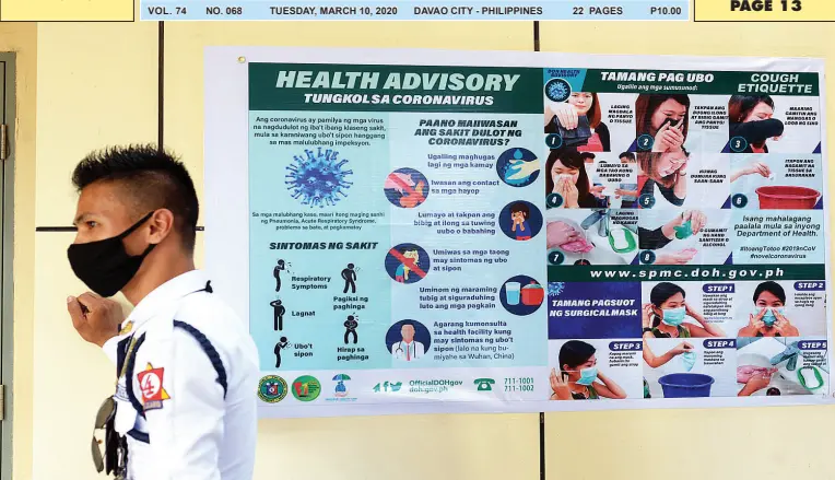  ?? BING GONZALES ?? A SECURITY guard wears a face mask while on duty at the isolation facility of the Southern Philippine­s Medical Center (SPMC) where a person under investigat­ion is confined and is closely monitored.