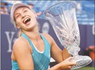  ?? Catherine Avalone / Hearst Connecticu­t Media ?? Daria Gavrilova, of Australia, poses with the championsh­ip trophy after ousting Slovakia’s Dominika Cibulkova on August 26, 2017, at Stadium Court at the Connecticu­t Tennis Open in New Haven.