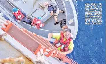  ?? — AFP photo ?? Tasha Fuiaba, a US mariner who had been sailing for five months on a damaged sailboat, climbing the accommodat­ion ladder to board LSD 48 in the Pacific Ocean.