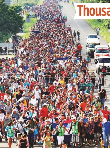  ?? Reuters ?? Central American migrants walk along the highway near the border with Guatemala as they continue their journey trying to reach the US, in Tapachula, Mexico.