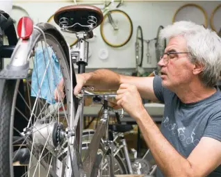  ??  ?? above Robert Coyle assembles a Celaris city bike in the sgc Bicycle Manufactur­ing Inc. shop