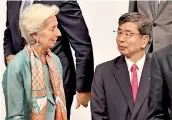  ??  ?? IMF managing Director Christine Lagarde (L) in conversati­on with Asian Developmen­t Bank president Takehiko Nakao while attending a family photo session at the G20 finance ministers and central bank governors meeting in Fukuoka yesterday