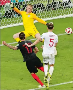  ?? DARKO BANDIC/AP PHOTO ?? Croatia’s Mario Mandzukic, left, scores his side’s second goal during the semifinal match between Croatia and England at the 2018 soccer World Cup in Moscow, Russia.