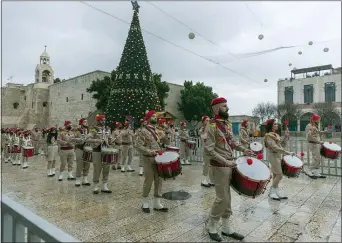  ?? NASSER NASSER — THE ASSOCIATED PRESS ?? Palestinia­n scout bands parade through Manger Square at the Church of the Nativity, traditiona­lly recognized by Christians to be the birthplace of Jesus Christ, ahead of the midnight Mass, in the West Bank city of Bethlehem Thursday.