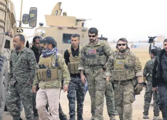  ??  ?? YPG militants and U.S. troops during a patrol near the Turkish border in Hasakah, Nov. 4.