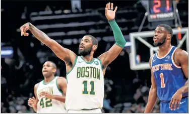  ?? N.Y. Post: Charles Wenzelberg (2) ?? ORDER RESTORED: Kyrie Irving, following through on a shot in Thursday’s 128-100 victory over Kevin Knox (right) and the Knicks, and the Celtics got revenge for a stunning upset loss on Nov. 21.