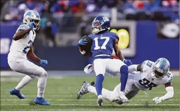  ?? Dustin Satloff / TNS ?? The Lion’s Jerry Jacobs (39) tackles Giants receiver Wan’Dale Robinson during the second half on Sunday in East Rutherford, N.J.