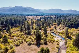  ?? ?? The 31-acre swath of land being acquired by the California Tahoe Conservanc­y in South Lake Tahoe is seen in an aerial photo.