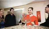  ?? MARY MATHIS/FOR THE WASHINGTON POST ?? Avital Barnea lights the menorah during a Hanukkah celebratio­n. She failed to find basics in Minneapoli­s.