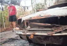  ?? LUKE FRANKE, NAPLES DAILY NEWS ?? Barry Barkman’s home survived a brush fire at Golden Gate Estates. His 1966 Ford Mustang Coupe wasn't so lucky.