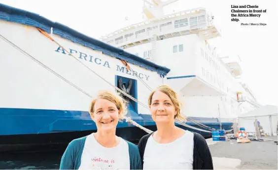  ?? Photo / Mercy Ships ?? Lisa and Cherie Chalmers in front of the Africa Mercy ship.