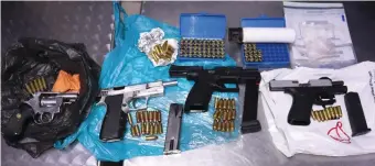  ??  ?? Firearms and ammunition confiscate­d during a raid at a home in Kwanokuthu­la.