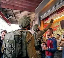  ??  ?? Israeli soldiers close the stores of Palestinia­ns in Hebron, West Bank, during a protest against US President Donald Trump’s announceme­nt to recognise Jerusalem as the capital of Israel.