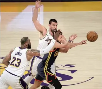  ?? Luis Sinco Los Angeles Times ?? LAKERS DEFENDERS LeBron James and Marc Gasol pressure Warriors guard Stephen Curry on Sunday night at Staples Center. The Lakers held Curry to 16 points and rolled to a 117-91 win.
