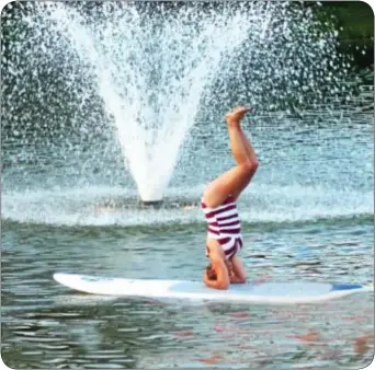  ??  ?? Members of PT Transforma­tions on Mill Street in Bristol demonstrat­ed paddleboat yoga.