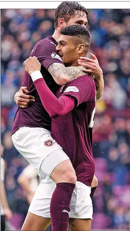  ??  ?? TOO EASY: Sam Nicholson (left) celebrates scoring his second for Hearts